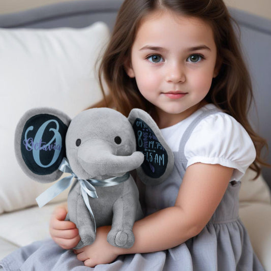 Personalised elephant plush baby gift; soft premium plush, 32 cm long, with a customisable head for birth announcements and nursery keepsakes.