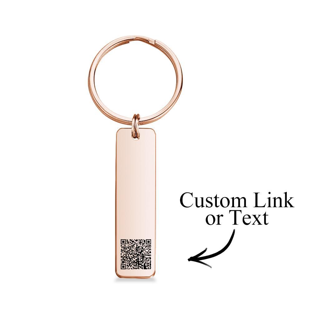 Personalised engraved QR code keychain close-up, laser-engraved scannable code on a mirror-polished stainless steel custom keyring, ideal personalised gift