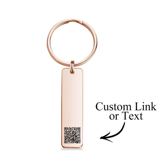 Personalised engraved QR code keychain close-up, laser-engraved scannable code on a mirror-polished stainless steel custom keyring, ideal personalised gift