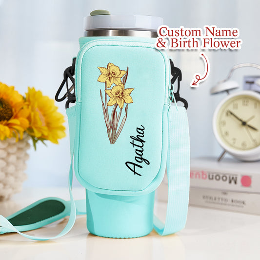 Personalised birth flower bottle bag in waterproof neoprene holding a 40oz Stanley tumbler with removable pouch and adjustable shoulder strap