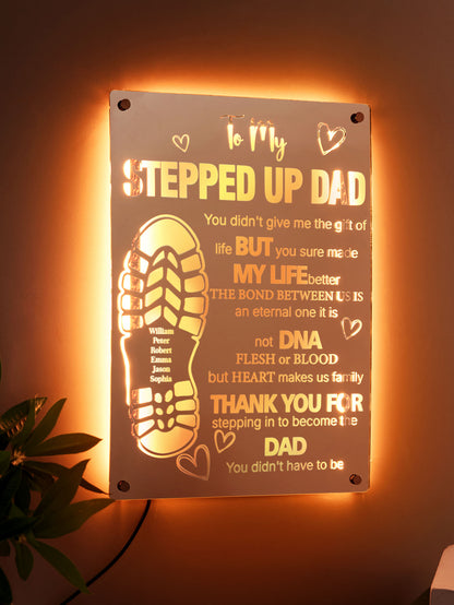 Close-up of an engraved dad's footprint on acrylic mirror light, showing precise engraving detail and LED edge illumination.