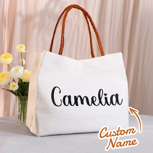 Front view of personalised name canvas tote bag with magnetic buckle, PU leather trim and leather-style handles — ideal gift for her