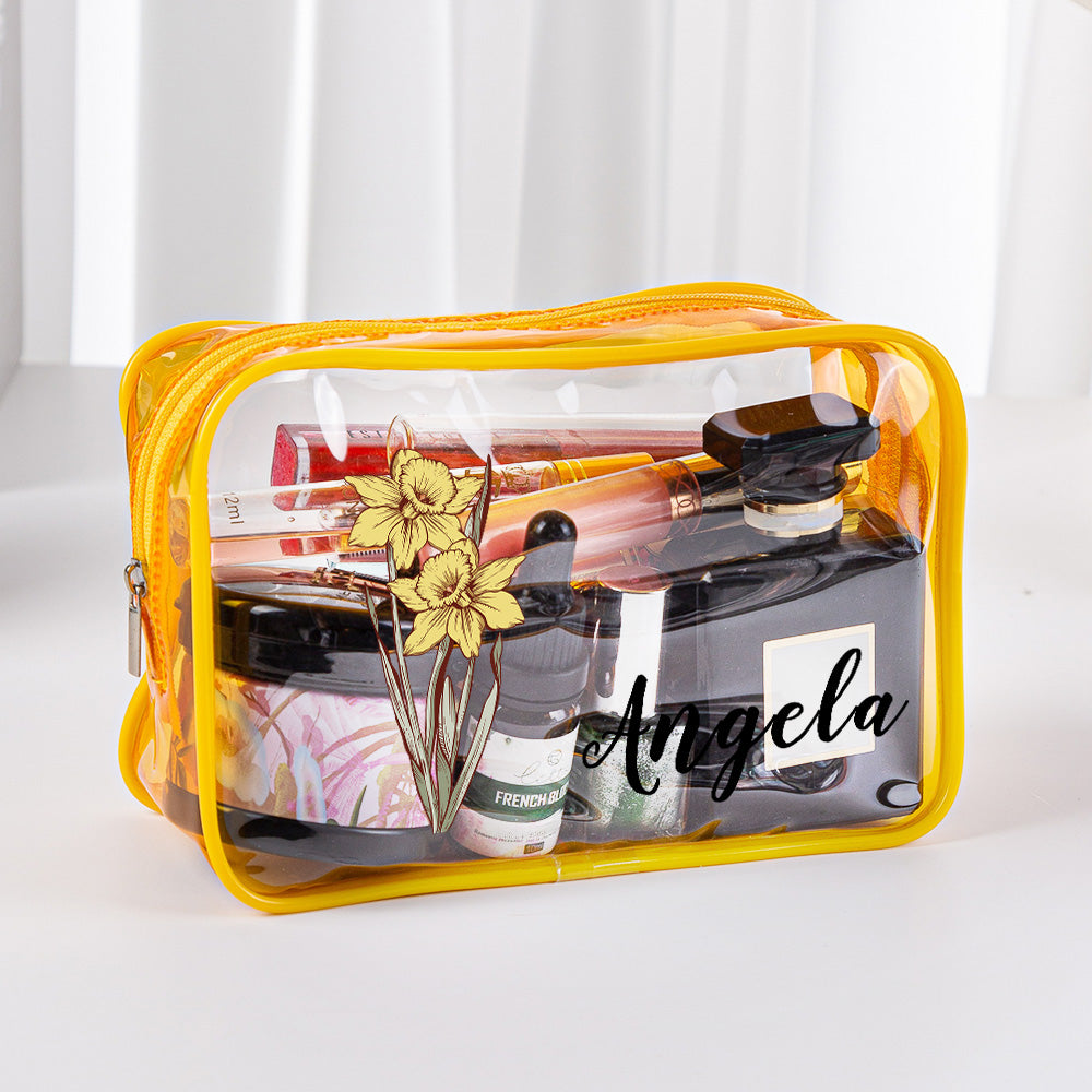 Open clear toiletry bag showing organised cosmetics and personalised birth flower print – practical travel toiletry bag