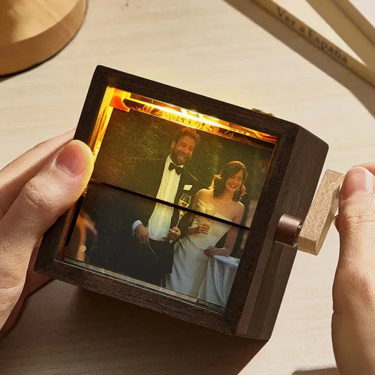 Personalised hand‑cranked flip book frame in black walnut displaying a sequence of photos — handcrafted mechanical photo album keepsake (8 or 16 photos)