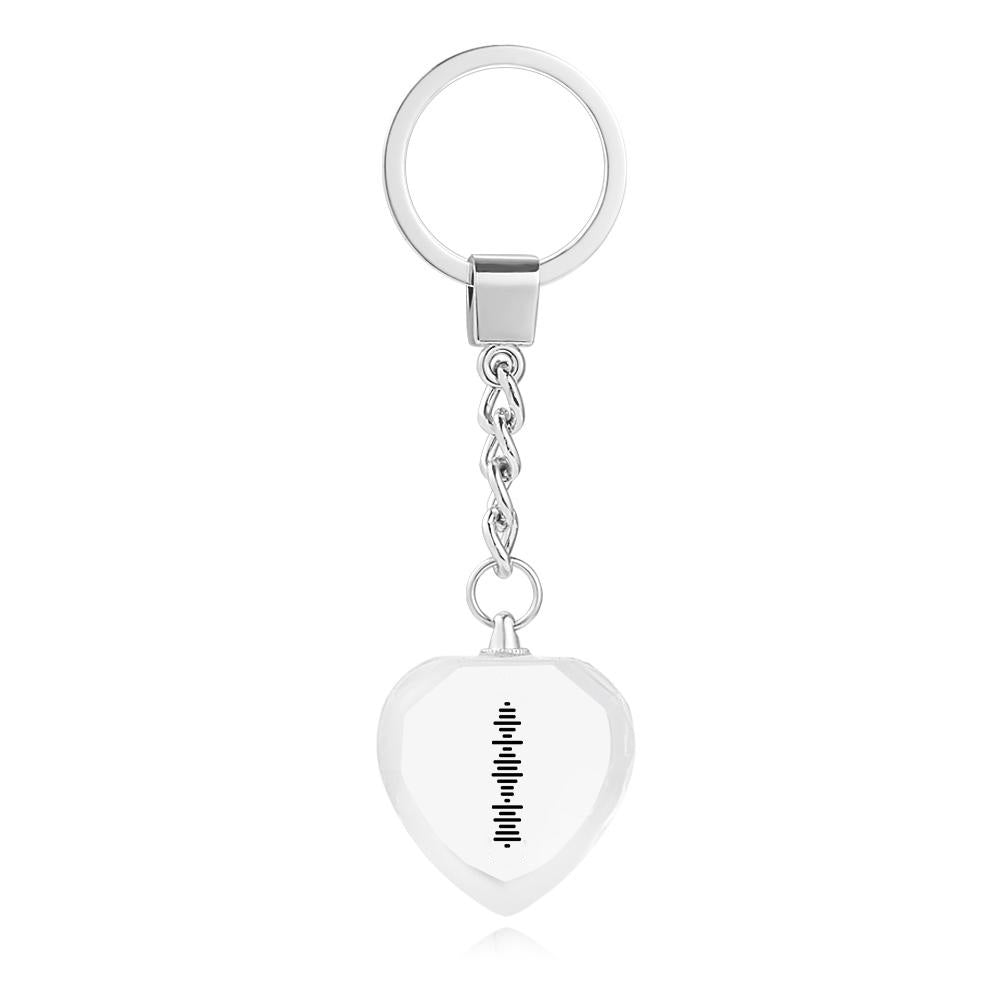 Close-up of single-sided UV printed engraving and scannable music code on heart-shaped crystal keyring showing three-dimensional depth effect