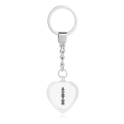 Close-up of single-sided UV printed engraving and scannable music code on heart-shaped crystal keyring showing three-dimensional depth effect