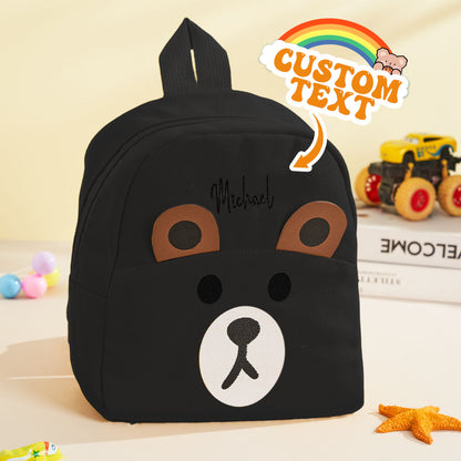 Close-up of mini bear motif and personalised name embroidery on children's backpack – custom school bag detail
