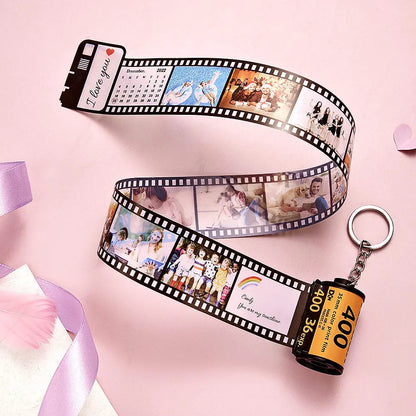 Personalised camera-roll keyring displaying a row of custom photos with personalised date and text – retro photo keychain gift