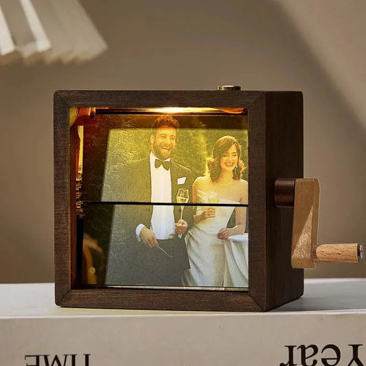 Personalised hand‑cranked flip book frame in black walnut displaying a sequence of photos — handcrafted mechanical photo album keepsake (8 or 16 photos)