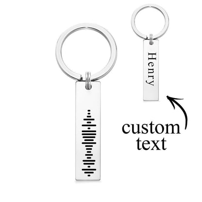 Close-up of precision laser-engraved Spotify music code on stainless steel 3D bar keyring showing scannable code and fine personalised text