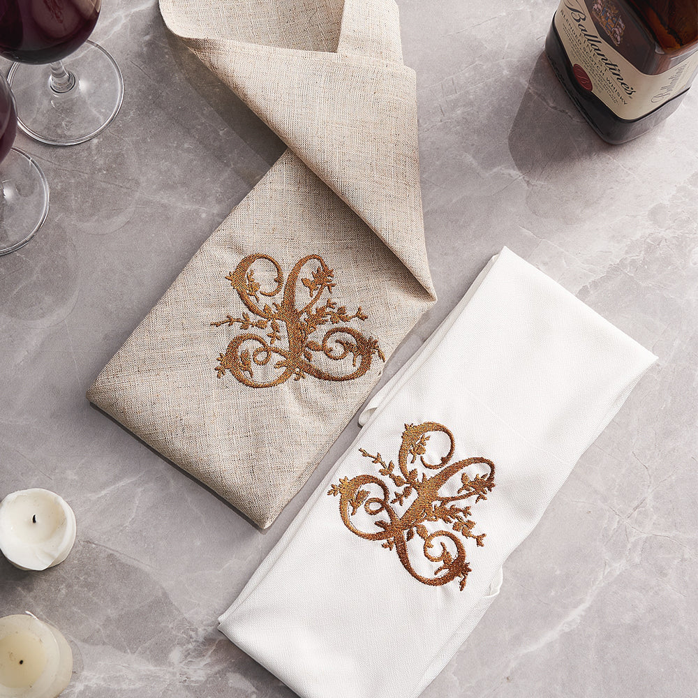 Personalised embroidered monogram linen napkin neatly folded on a place setting — ideal bridesmaid or wedding gift