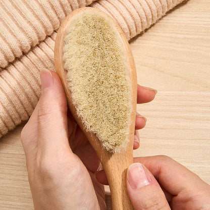 Wooden baby comb showing smooth, rounded teeth to protect the scalp — essential piece of a personalised newborn grooming set