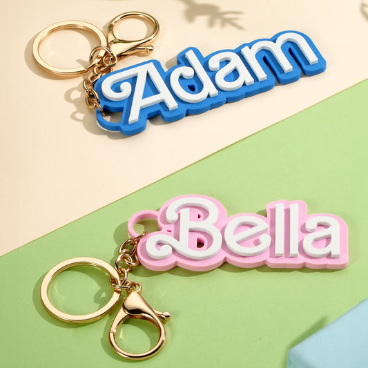 Personalised backpack name tag in bright colours hanging from a school rucksack showing custom engraved name kids' bag charm back to school gift