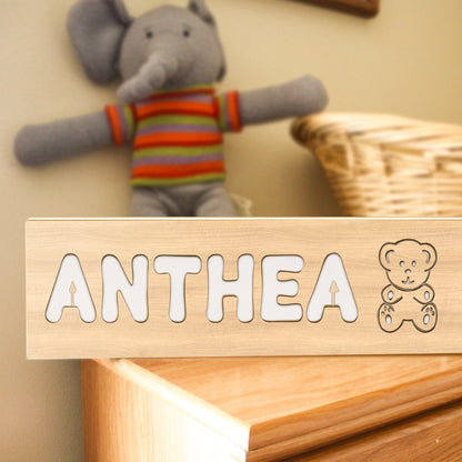 Engraved name close-up on a wooden panel of a personalised baby night light demonstrating fine laser-cut detail — engraved name lamp