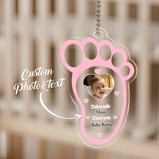 Close-up of the baby footprint motif on personalised acrylic car mirror hanger.