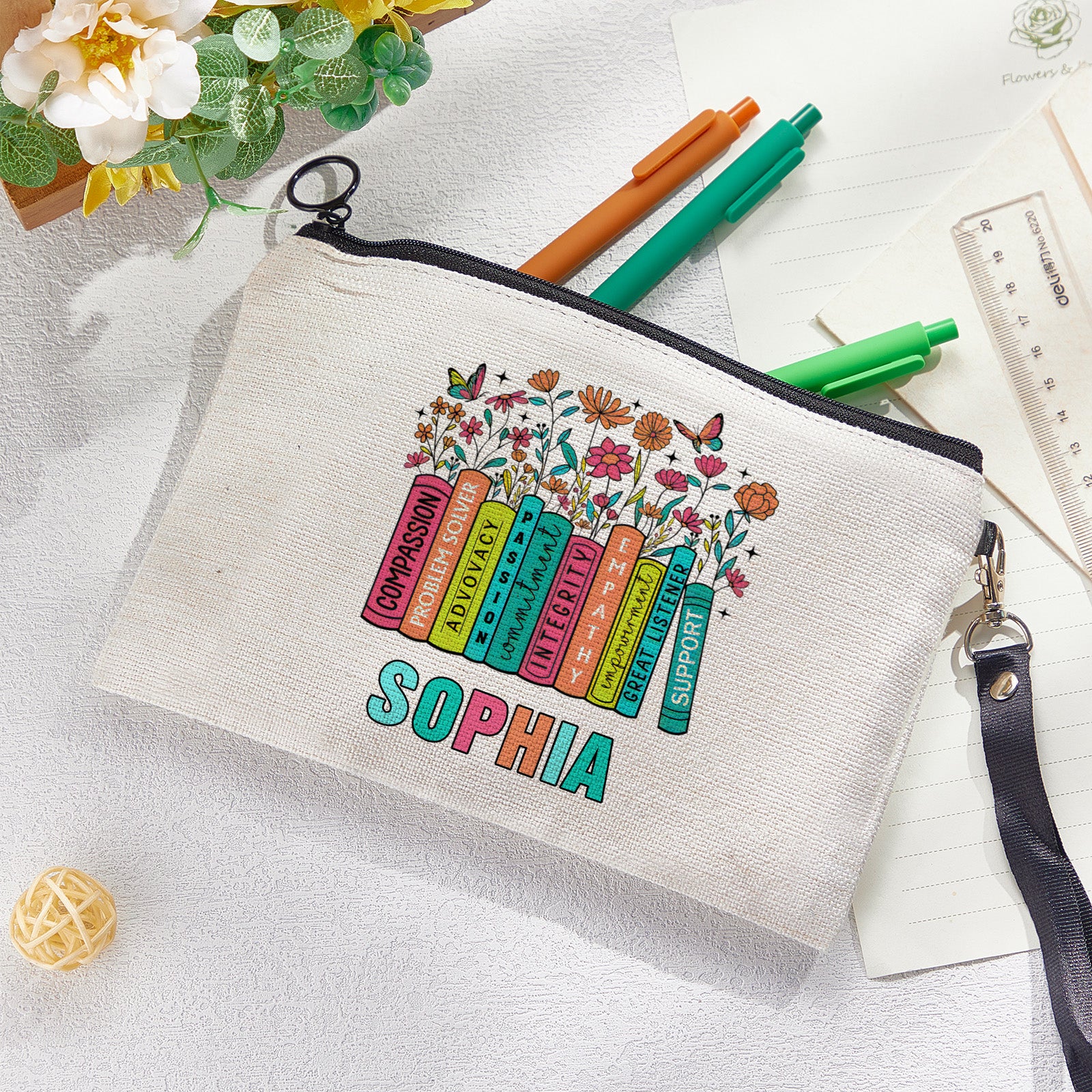 Flat-lay of personalised floral make-up and pencil bag alongside school supplies for back-to-school gifting