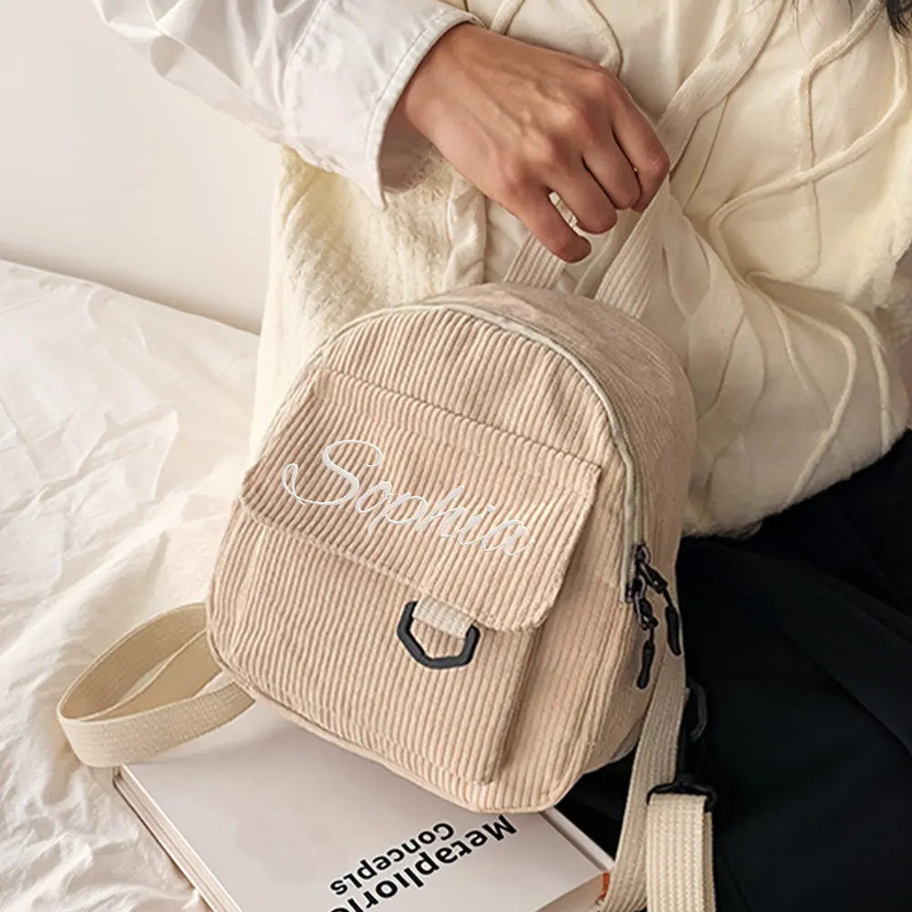 Close-up of embroidered name on mini corduroy backpack highlighting neat stitching — embroidered name backpack detail