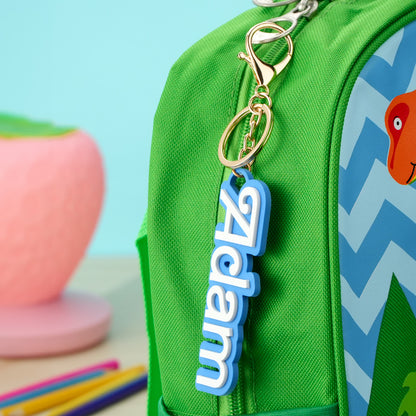 Selection of colourful personalised backpack name tags laid flat displaying different names and fonts ideal back to school gifts