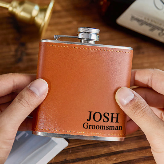 Personalised 6oz whiskey flask wrapped in premium PU leather with deep engraved name on stainless-steel body — perfect groomsmen or father gift