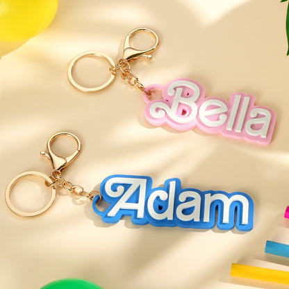 Close up of engraved personalised name on PLA bag charm showing clear custom text personalised name gifts for children