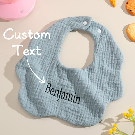 Personalised cotton baby bib with embroidered name on a white background — perfect newborn gift and baby shower present