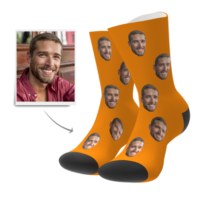 Pair of personalised photo socks showing custom face print — high-quality heat-transfer, available in ten colours