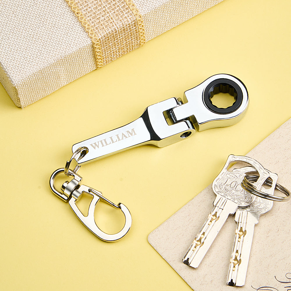 Close-up of bespoke engraving on stainless steel mini ratchet wrench keyring with 10mm socket, personalised keepsake gift