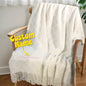 Front view of a soft cotton personalised tassel blanket for kids, featuring an embroidered name and decorative tassels.