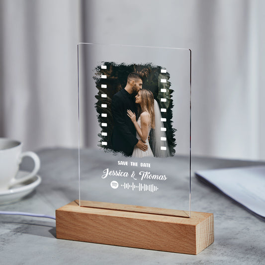 Angled view of the personalised Spotify Music Photo Plaque and keychain set in clear acrylic, highlighting the engraved code and photo.