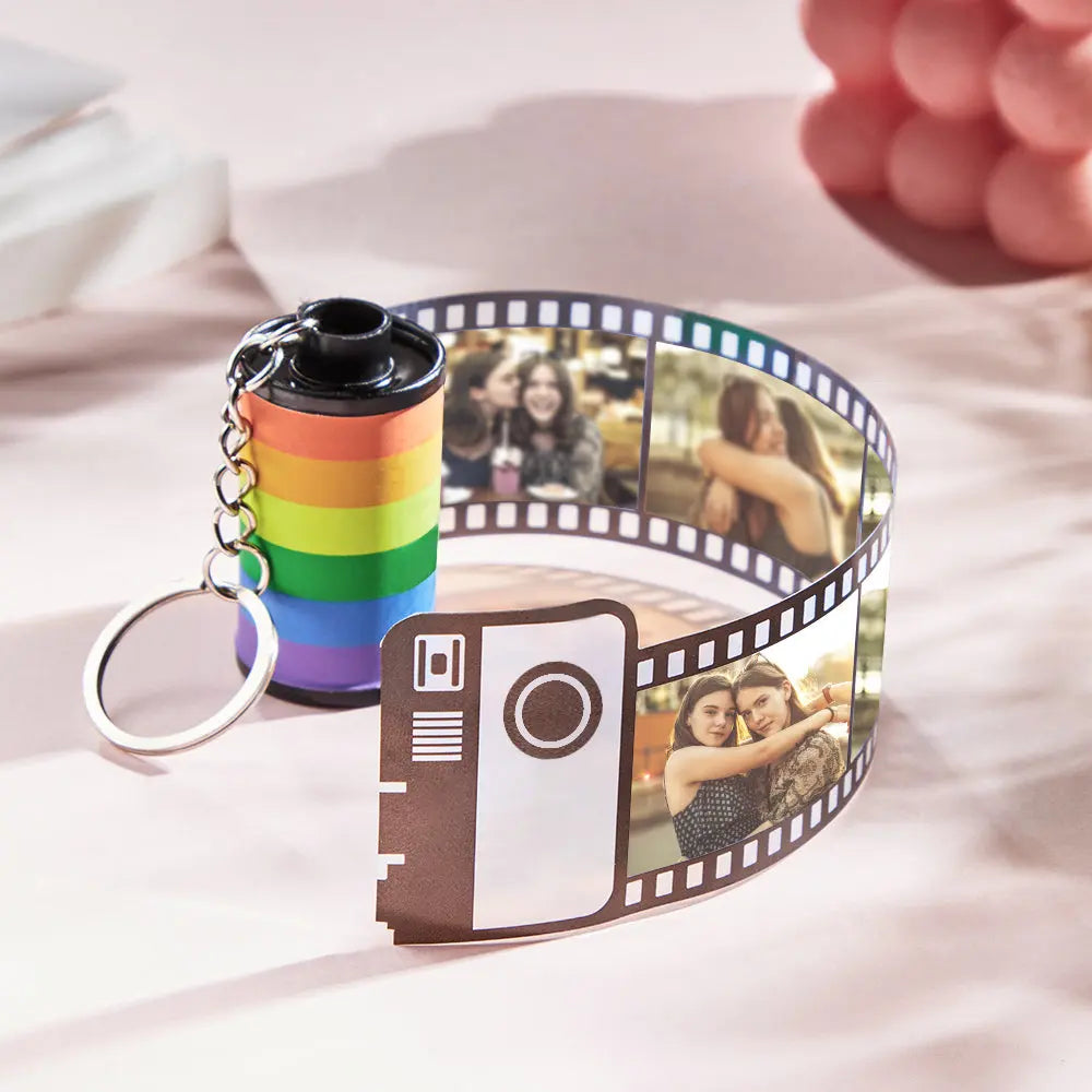 Personalised rainbow film roll keyring on a split ring with ornate jewellery-style finish — durable plastic multiphoto keepsake for anniversaries and Pride