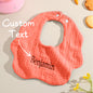 Close-up of embroidered name on a personalised baby bib showing neat stitching — embroidered name bib detail