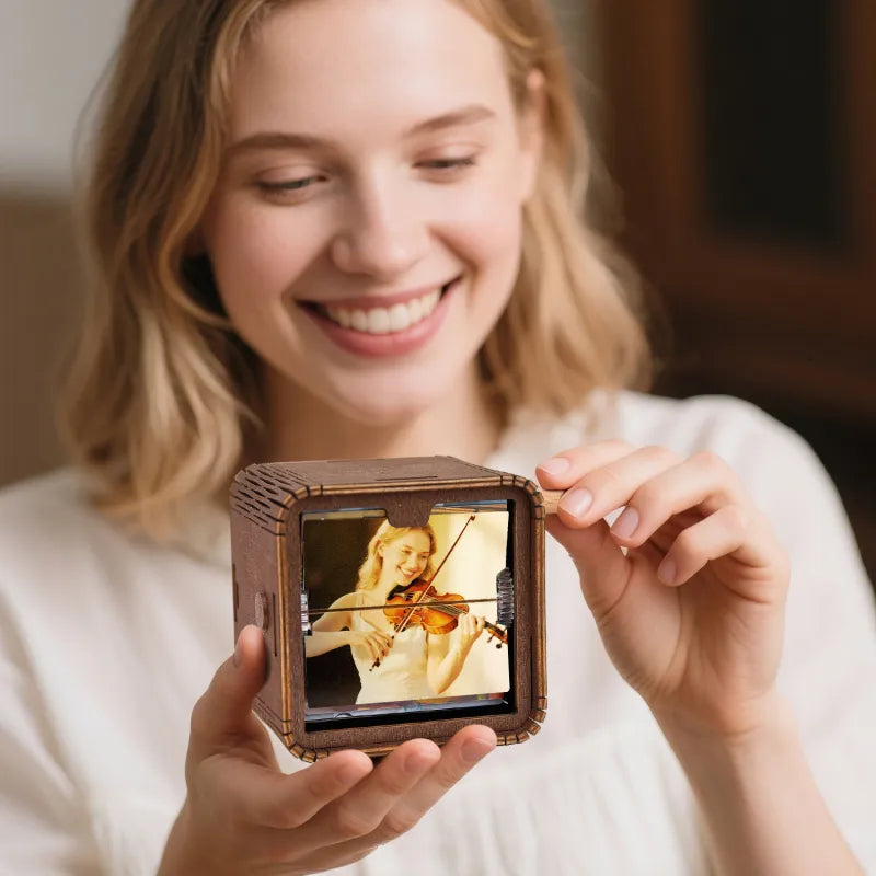 Side view of personalised hand-crank flipbook frame showing wood and PVC construction, compact 9x9x7.5 cm