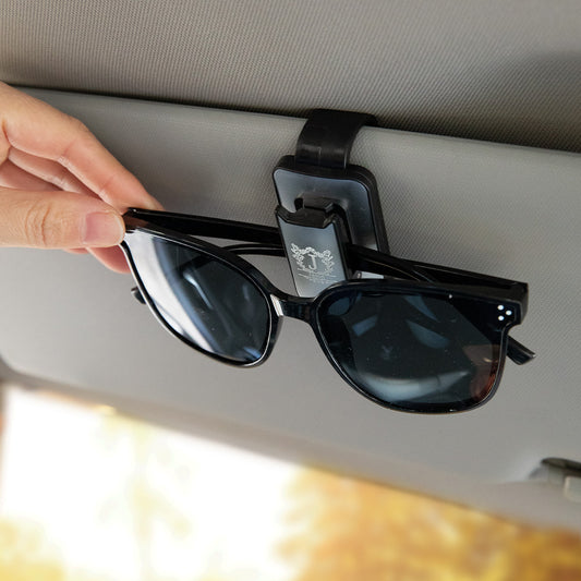 Close-up of the personalised sun visor clip, highlighting the engraved or printed custom name feature.