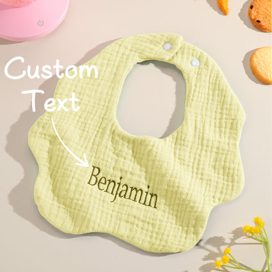 Personalised cotton baby bib with embroidered name on a white background — perfect newborn gift and baby shower present