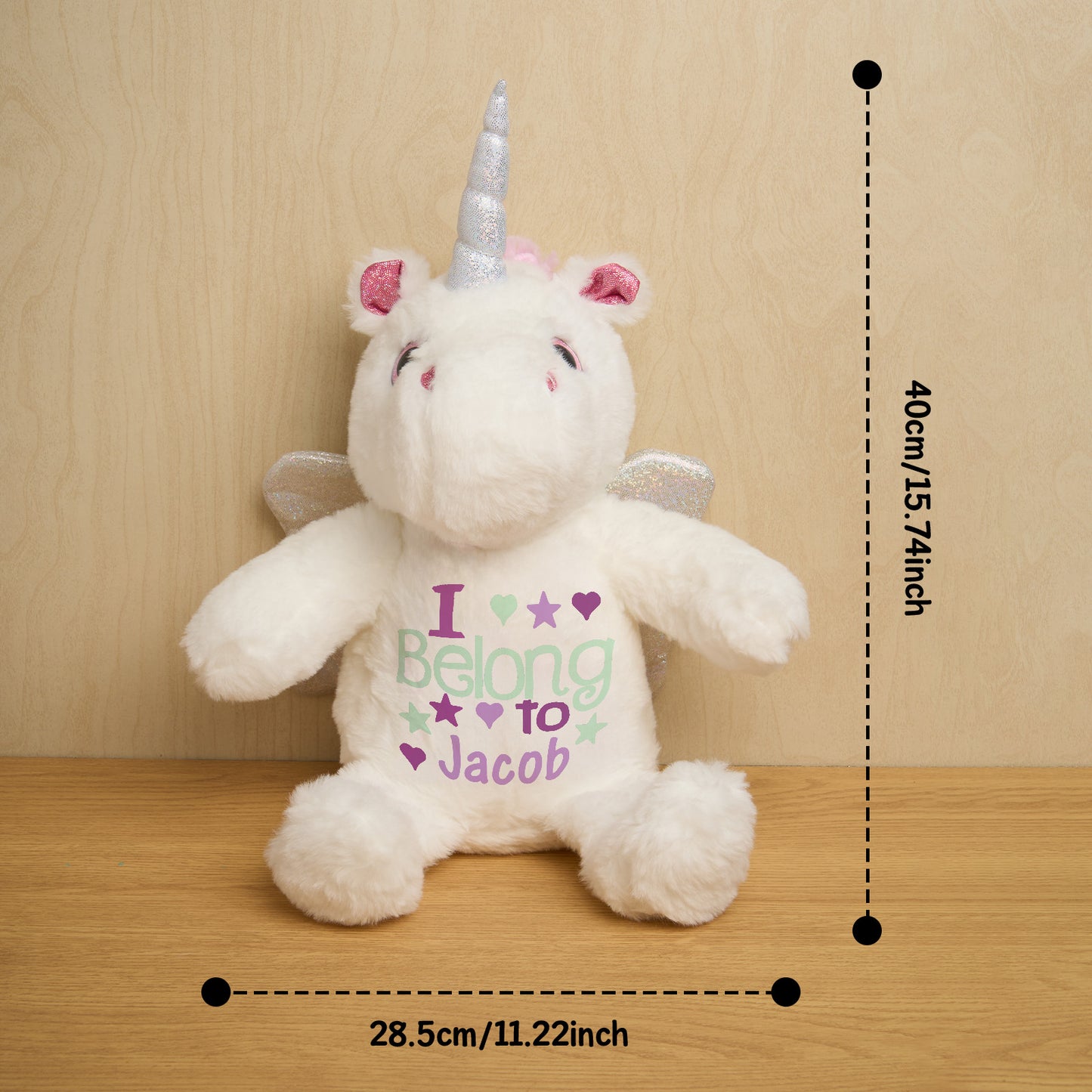 Personalised unicorn plush beside a measuring reference to show dimensions, custom baby name soft toy and nursery decor item
