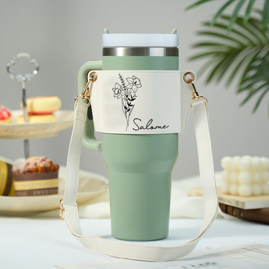 Personalised birth flower 40oz tumbler carrier bag in PU leather with adjustable strap, shown with a 40oz Stanley tumbler — stylish personalised gift for her