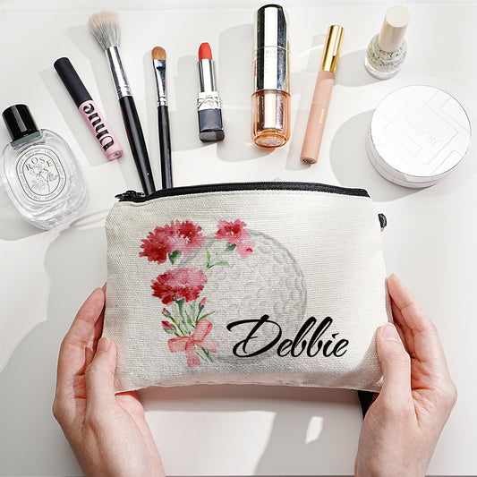 Personalised canvas makeup bag front view showing custom name, birth flower illustration and golf ball motif — durable travel cosmetics pouch with secure zip closure