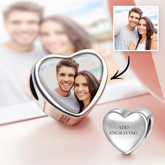 Close-up of personalised engraved heart photo charm with copper base and silver-plated oil-drip finish, double-sided clear photo — keepsake for bracelet or necklace