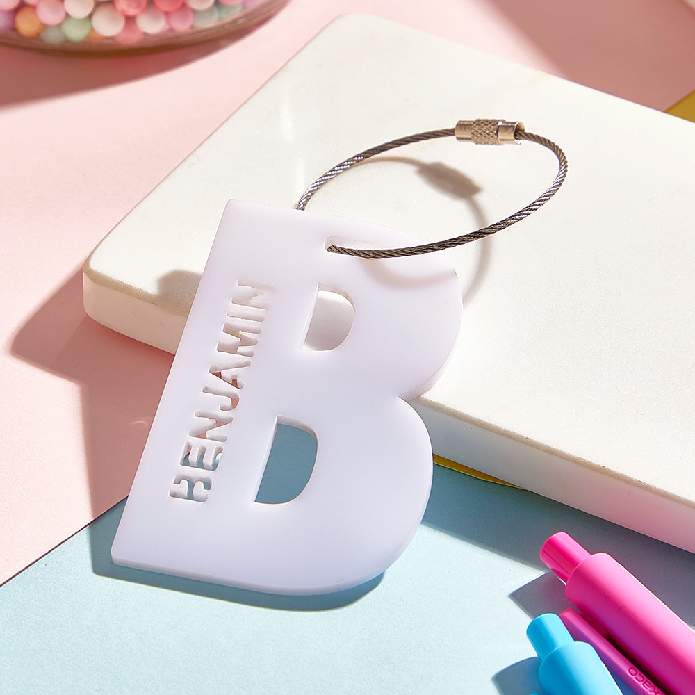 Gift-styled photo of a personalised acrylic name tag as a thoughtful present for him or her, perfect back-to-school or travel gift