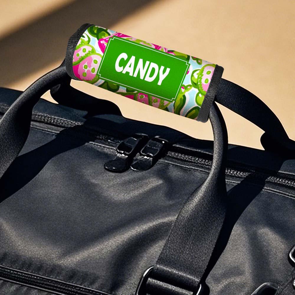 Pair of neoprene personalised luggage handle wraps on suitcases — easy-to-spot ID for busy baggage reclaim areas