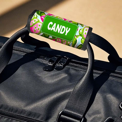 Pair of neoprene personalised luggage handle wraps on suitcases — easy-to-spot ID for busy baggage reclaim areas