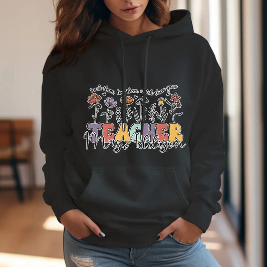 Personalised wildflower hooded sweatshirt shown from the back with floral artwork and custom name — perfect personalised teacher gift and custom name hoodie for back-to-school