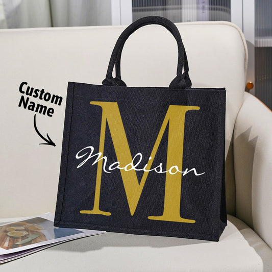 Main product shot of personalised black canvas tote with custom name and initial on the front — stylish, durable gift for birthdays, weddings and everyday use