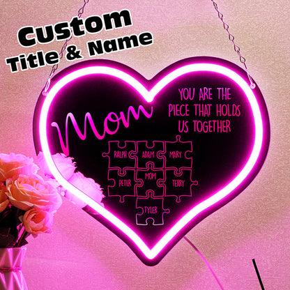 Scale demonstration showing hands holding the Personalised Mum Puzzle Sign (29.5cm x 25.6cm) to illustrate size of the personalised neon mirror gift with kids' names