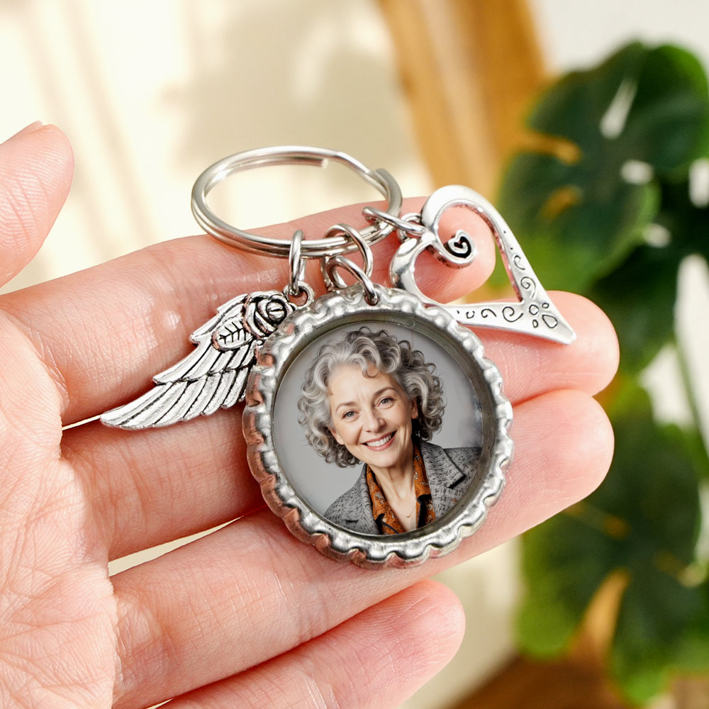 Engraved reverse of personalised heart wing keychain with custom name and message, durable alloy finish