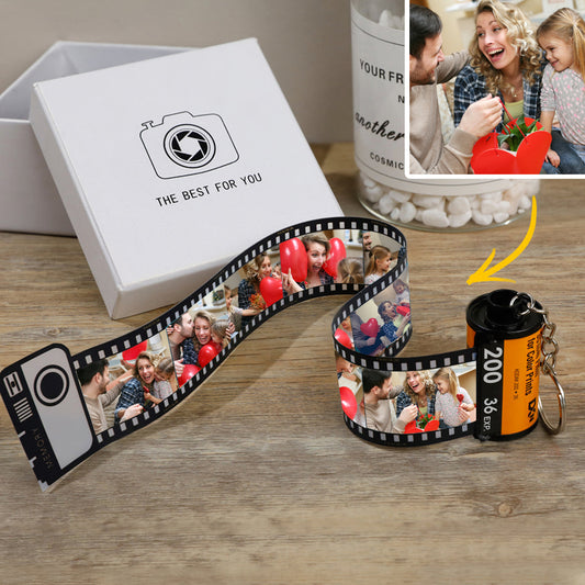 Personalised camera film-roll keychain with multiple photos and a gift box.