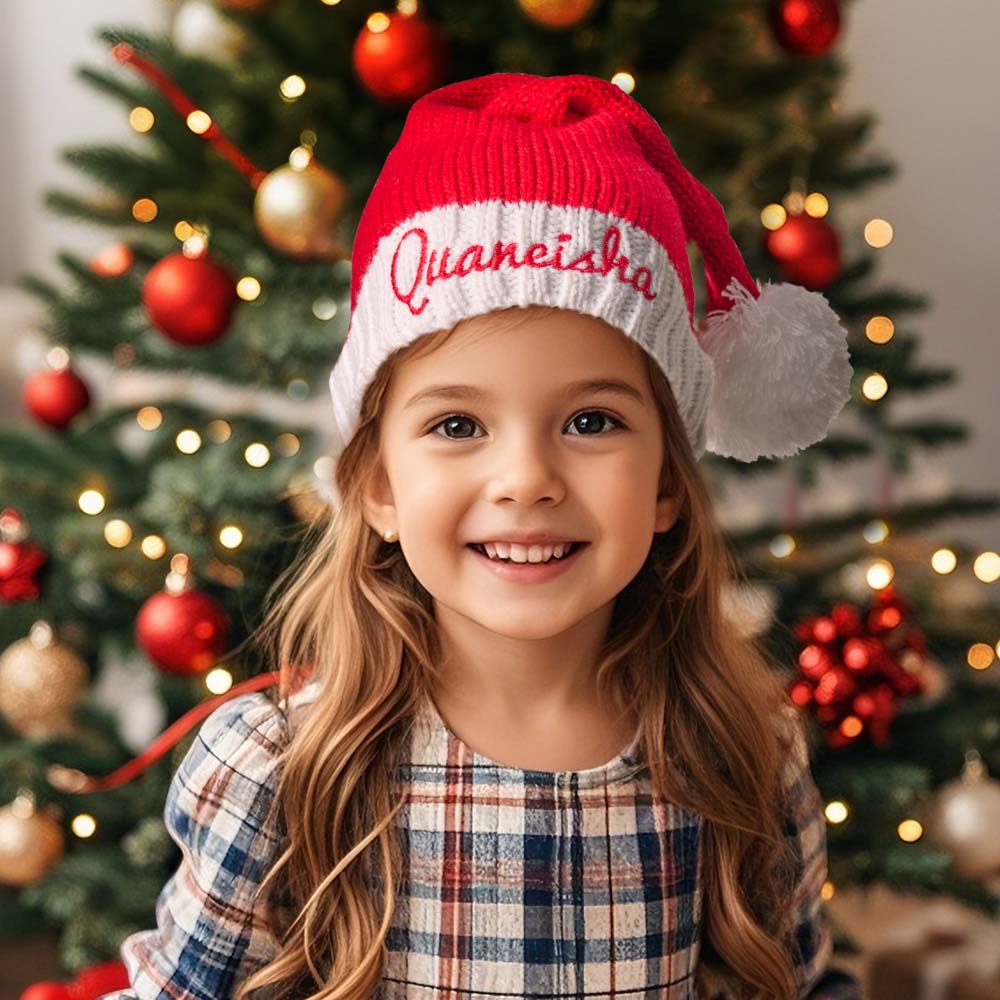 Child wearing a personalised embroidered Santa hat with a custom name — ideal personalised name gift for kids and matching family sets