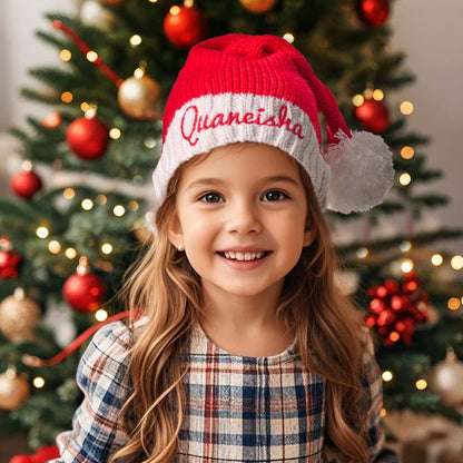 Child wearing a personalised embroidered Santa hat with a custom name — ideal personalised name gift for kids and matching family sets