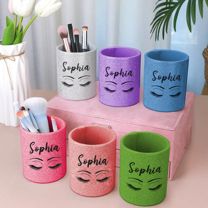 Personalised glitter leather makeup brush holder with custom name on glitter panel, compact leather brush cup filled with brushes on a dressing table — perfect personalised vanity cup and travel brush organiser