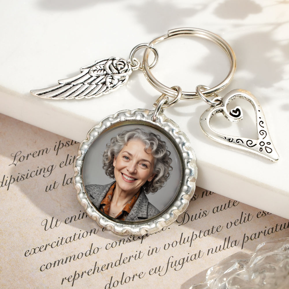 Close-up of personalised photo insert in heart wing keychain showing clear printed image and crisp engraving